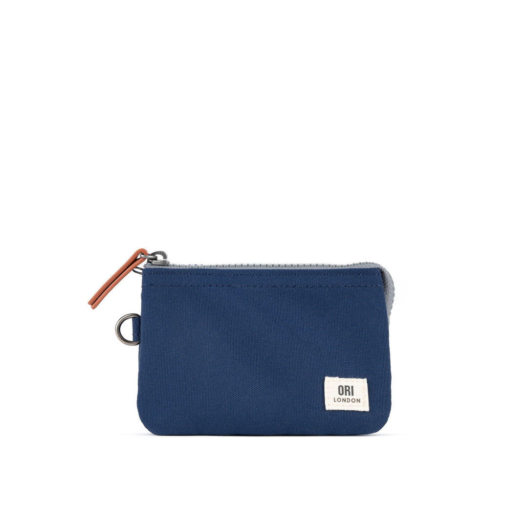 A compact, weather-resistant Crisp Blue Ori Carnaby canvas zip-around wallet with internal card slots, available at Be Charmed.