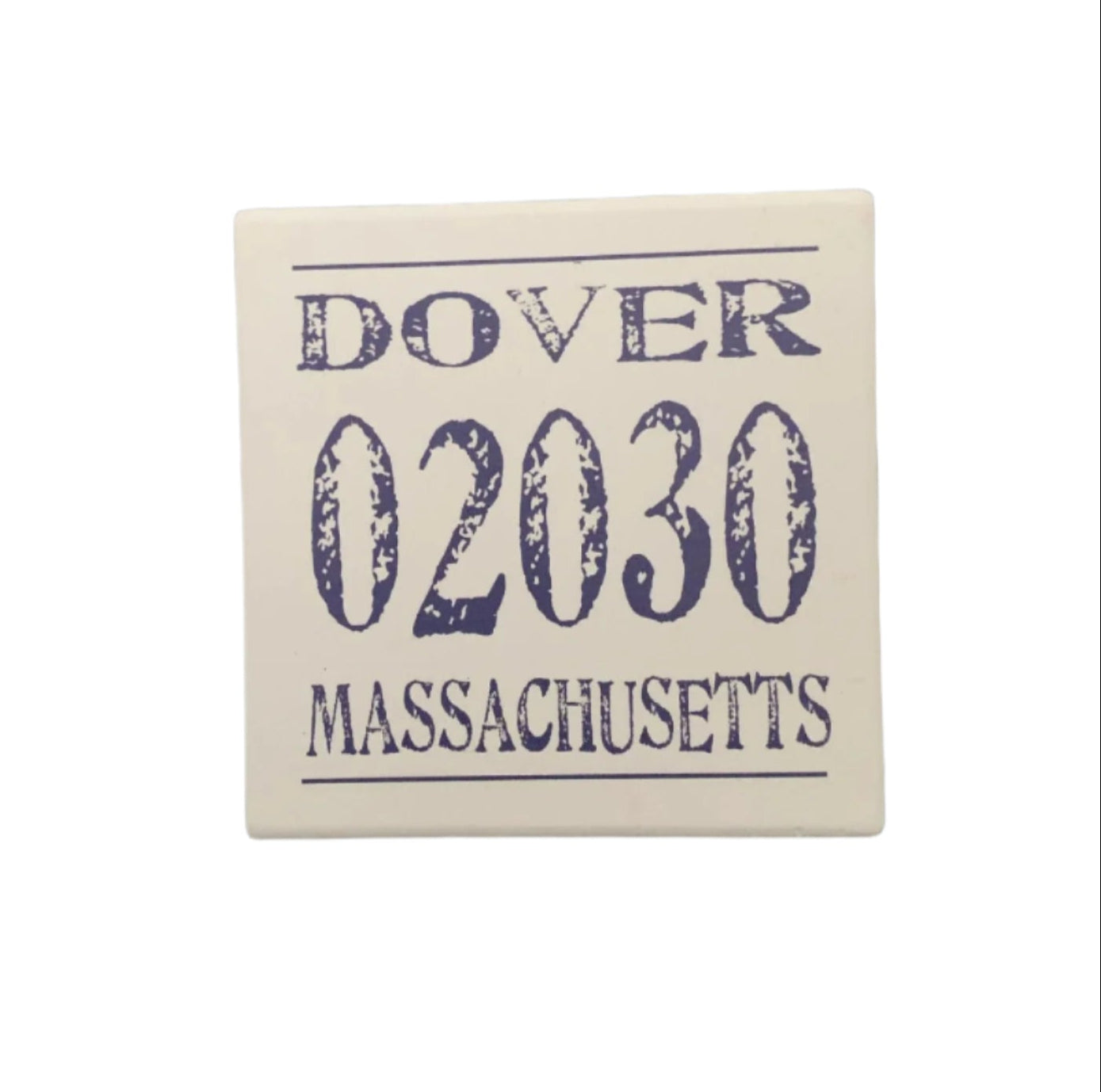 A square ceramic coaster with 'DOVER 02030 MASSACHUSETTS' printed in blue ink. Available at Be Charmed