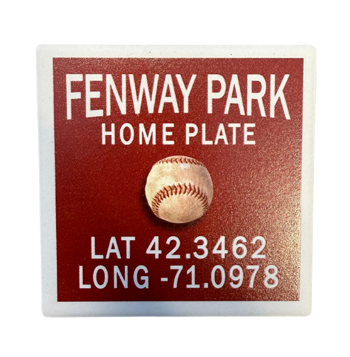 A square coaster with rounded edges featuring an image of a baseball and text including 'Fenway Park Home Plate' and coordinates 'Lat 42.3462 Long -71. Available at Be Charmed