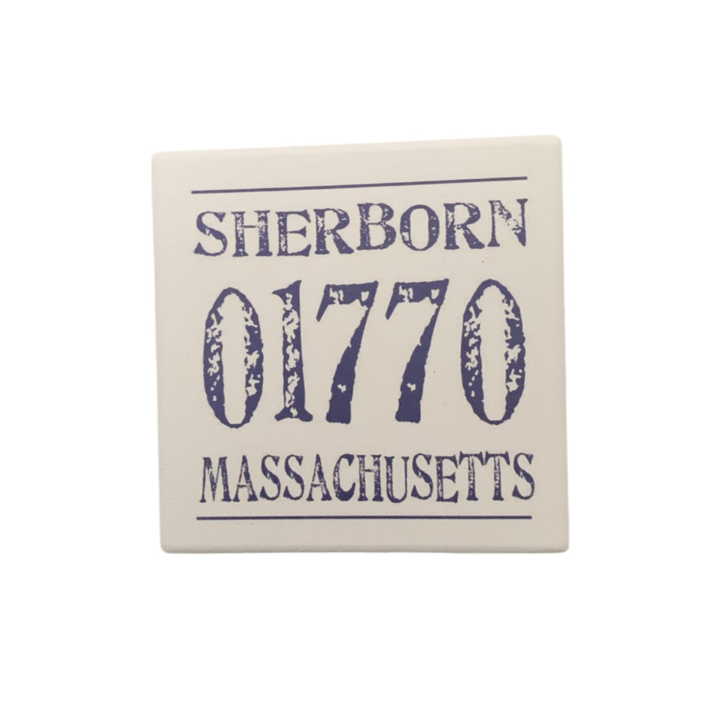 A beige ceramic coaster with the text 'SHERBORN 01770 MASSACHUSETTS' in blue. Available at Be Charmed
