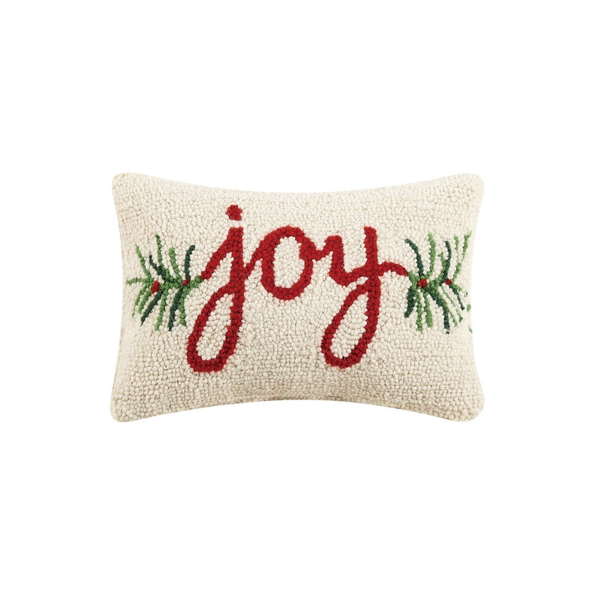 Decorative pillow with 'joy' and greenery on a white background. Available at Be Charmed
