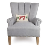 Gray armchair with a 'joy' pillow on a white background. Available at Be Charmed