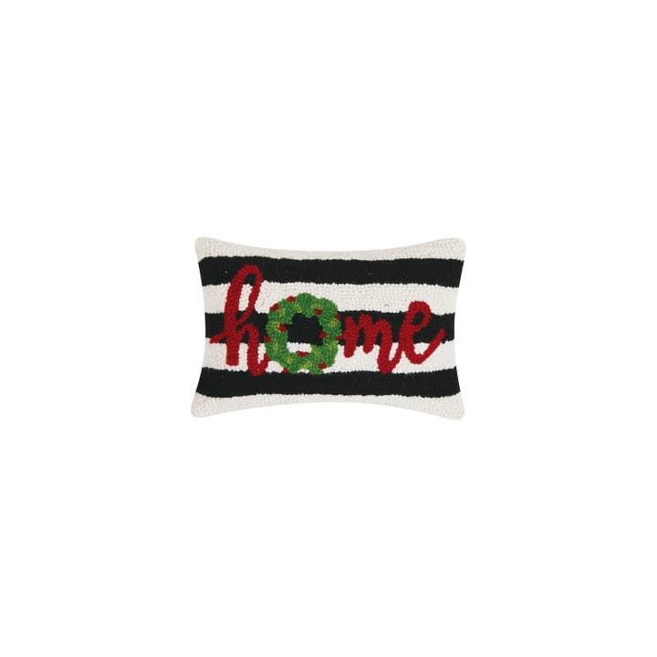 Decorative pillow with 'home' and wreath design on a black and white striped background. Available at Be Charmed