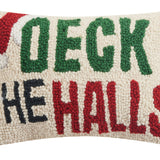 Decorative pillow with 'Deck the Halls' text in green, red, and black on a white background. Available at Be Charmed