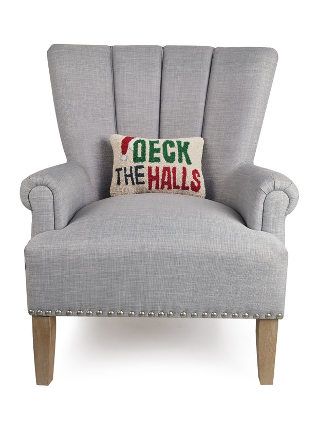 Gray armchair with a 'Deck the Halls' pillow on a white background. Available at Be Charmed