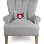 Gray armchair with a decorative pillow featuring a red mug design on a white background. Available at Be Charmed