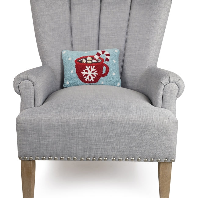 Gray armchair with a decorative pillow featuring a red mug design on a white background. Available at Be Charmed