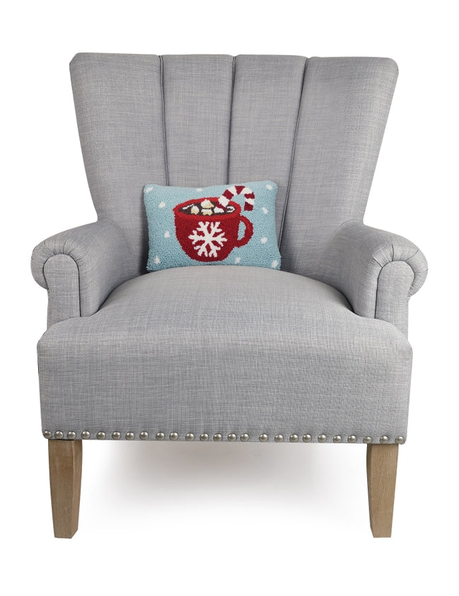 Gray armchair with a decorative pillow featuring a red mug design on a white background. Available at Be Charmed