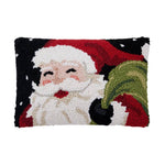 Decorative pillow with a festive design of Santa Claus holding a green bag on a white background. Available at Be Charmed