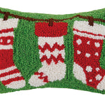 Decorative pillow with red and white stockings on a green background. Available at Be Charmed