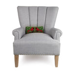 Gray armchair with a decorative pillow featuring cardinals on a white background. Available at Be Charmed
