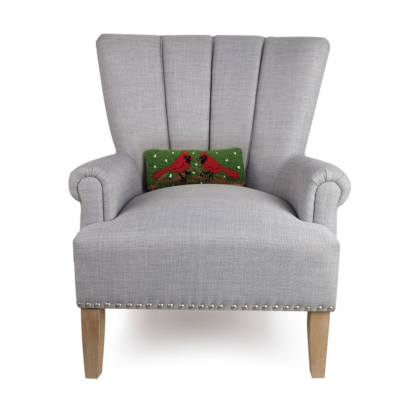 Gray armchair with a decorative pillow featuring cardinals on a white background. Available at Be Charmed