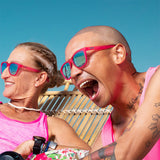 People wearing Goodr Flamingos on a Booze Cruise sunglasses with bright pink frames, polarized lenses, and no-slip grip—fun, functional eyewear at Be Charmed.