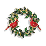 Wreath-shaped brooch with red cardinals and green leaves on a white background. Available at Be Charmed. 