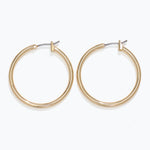 Gold hoop earrings on a white background. Available at Be Charmed
