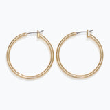 Gold hoop earrings on a white background. Available at Be Charmed