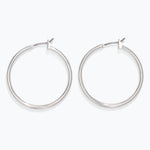 Pair of silver hoop earrings on a white background. Available at Be Charmed