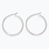 Pair of silver hoop earrings on a white background. Available at Be Charmed