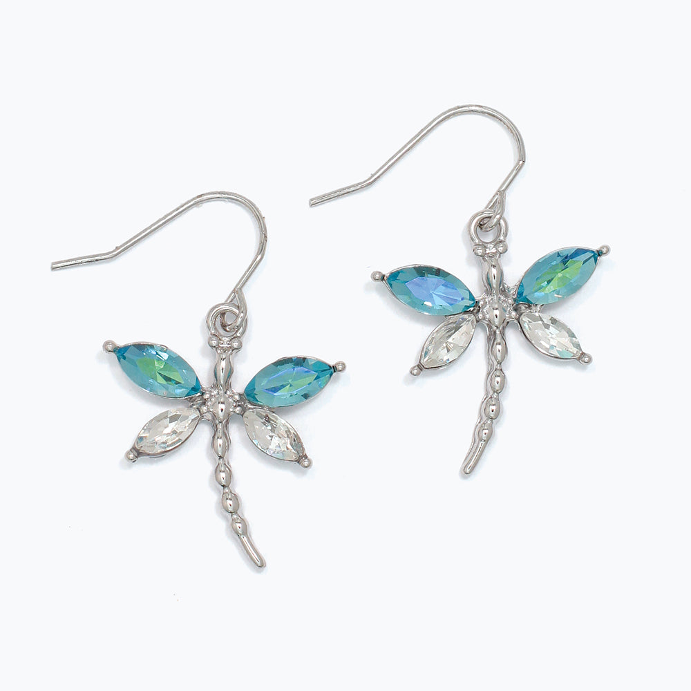 Dragonfly-shaped earrings with blue gemstones on a white background. Available at Be Charmed