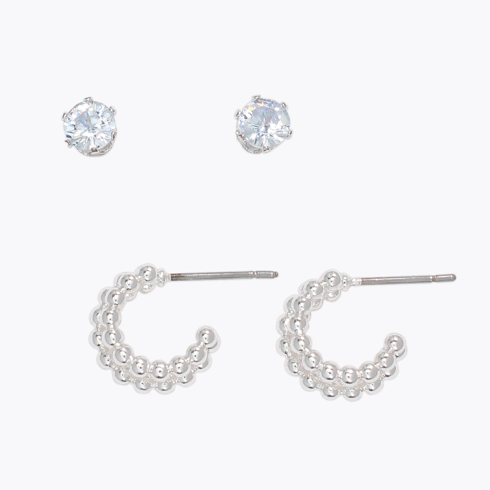Set of silver hoop earrings on a white background. Available at Be Charmed