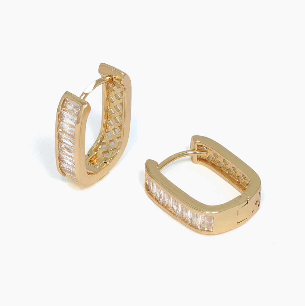 Gold hoop earrings with cz gemstones on a white background. Available at Be Charmed