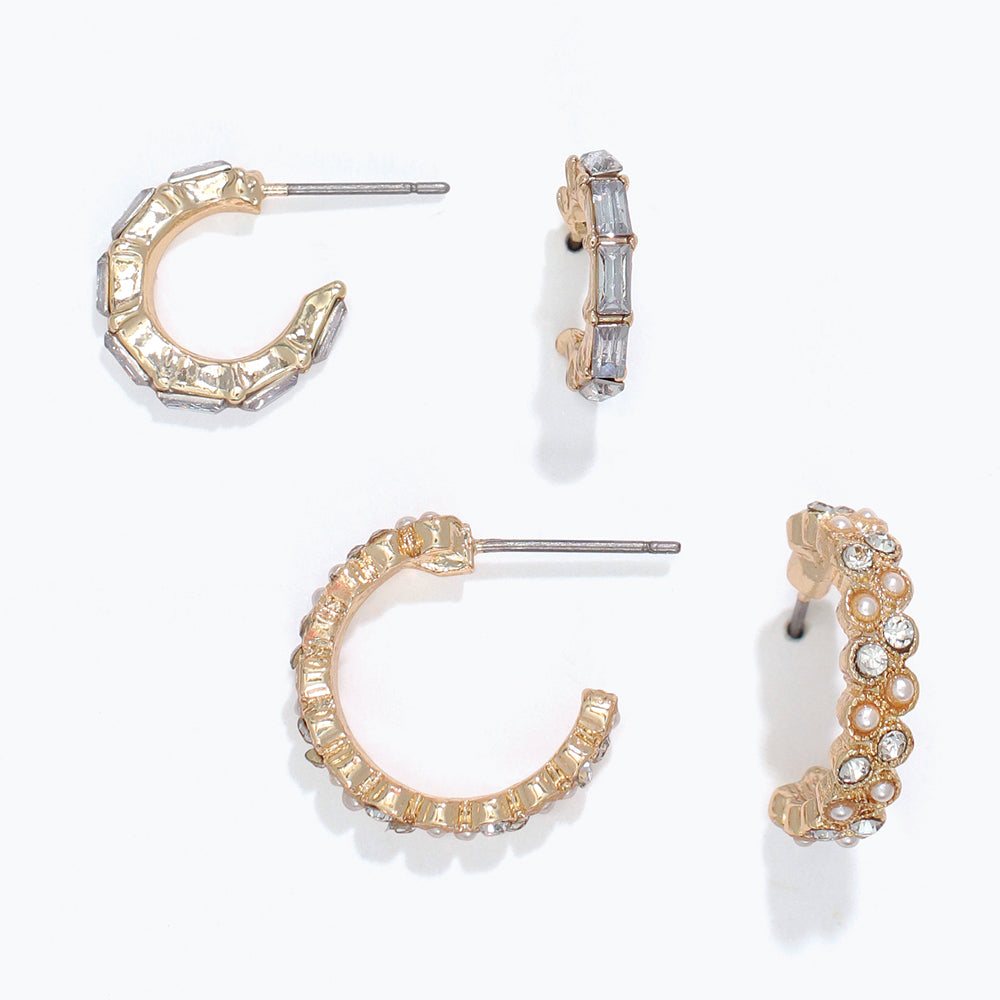 Set of gold hoop earrings with various designs on a white background. Available at Be Charmed