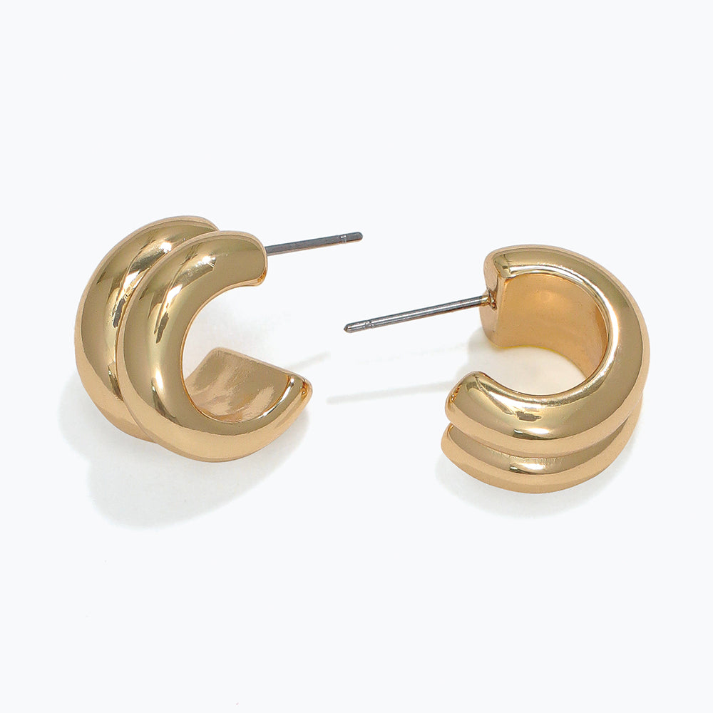 Gold hoop earrings on a white background. Available at Be Charmed