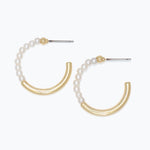 Pair of gold and pearl earrings on a white background. Available at Be Charmed
