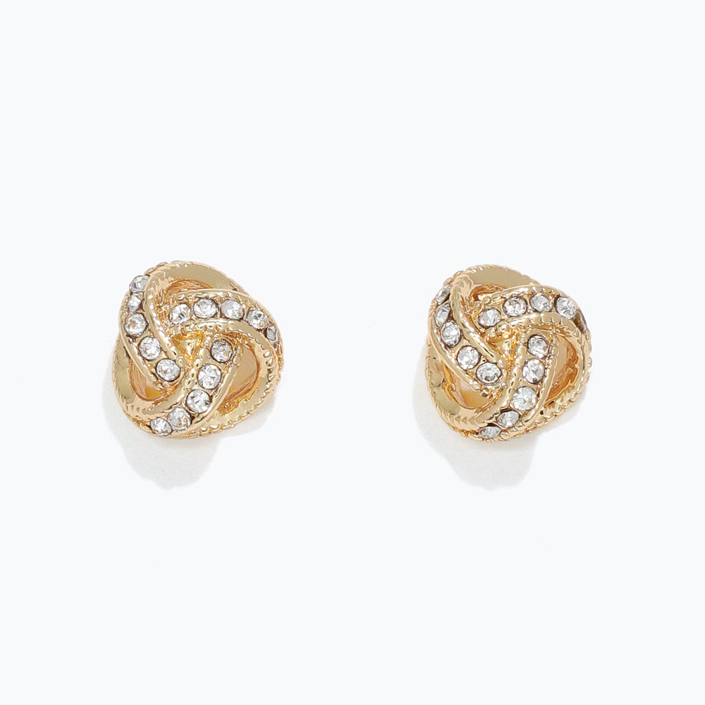 Gold earrings with intricate design and clear stones on a white background. Available at Be Charmed