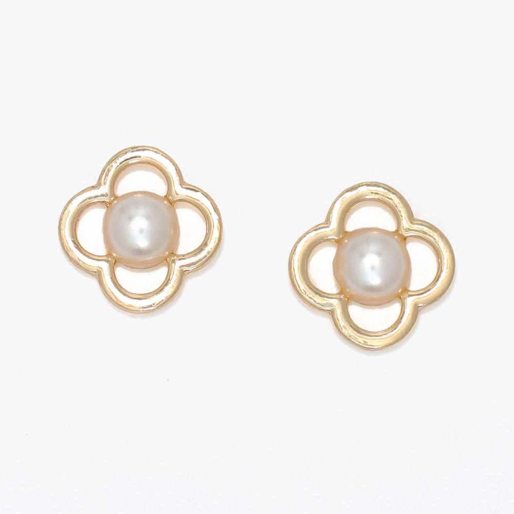 Pair of gold earrings with pearl centers on a white background .Available at Be Charmed