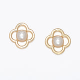 Pair of gold earrings with pearl centers on a white background .Available at Be Charmed