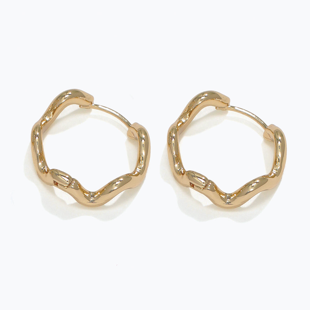 Gold hoop earrings on a white background. Available at Be Charmed
