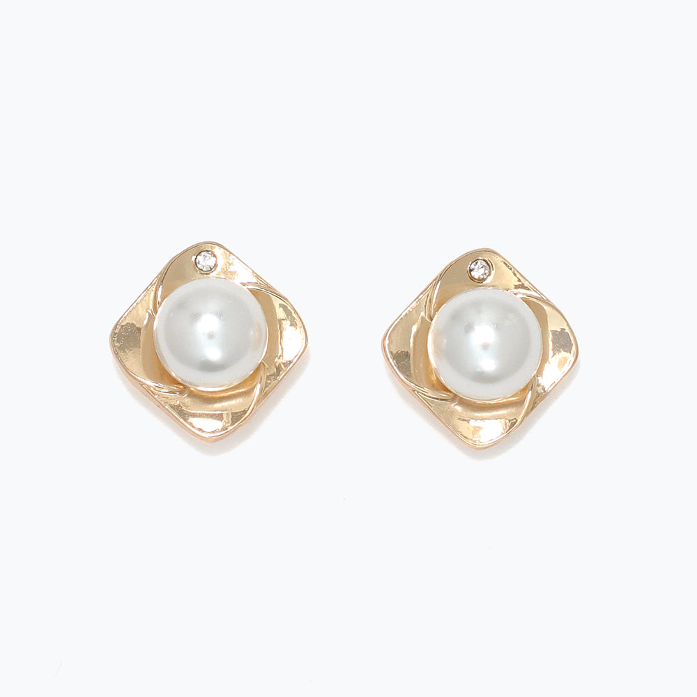 Pair of gold earrings with pearl centers on a white background. Available at Be Charmed