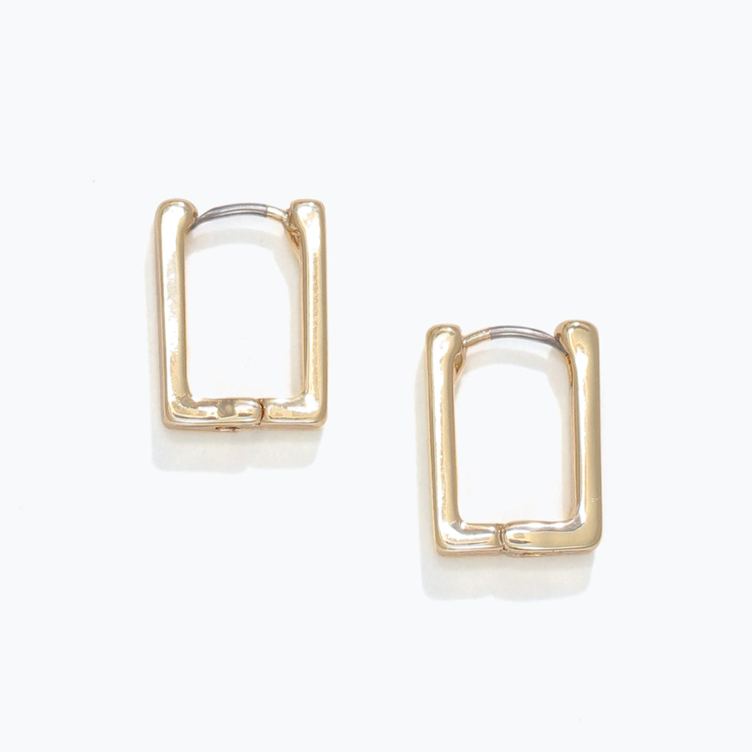 Gold hoop earrings on a white background. Available at Be Charmed