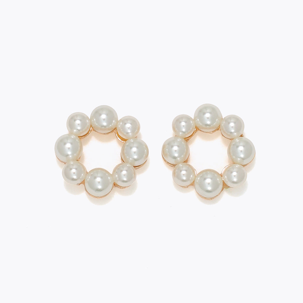 Pair of pearl hoop earrings on a white background. Available at Be Charmed