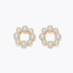 Pair of pearl hoop earrings on a white background. Available at Be Charmed