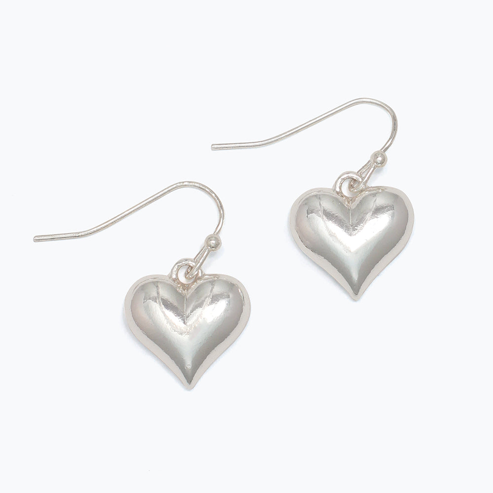 Heart-shaped silver earrings on a white background. Available at Be Charmed
