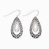 Silver teardrop earrings with intricate designs on a white background. Available at Be charmed