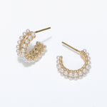 Gold hoop earrings with pearl accents on a white background. Available at Be Charmed