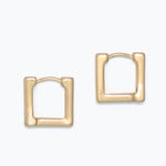 Gold hoop earrings on a white background. Available at Be Charmed