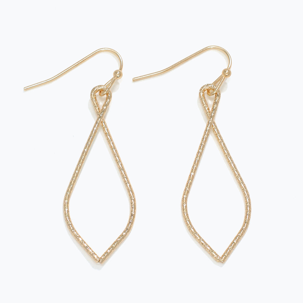 Gold teardrop earrings on a white background. Available at Be Charmed