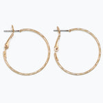 Gold hoop earrings on a white background. Available at Be Charmed