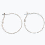 Silver hoop earrings on a white background. Available at Be Charmed