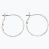 Silver hoop earrings on a white background. Available at Be Charmed