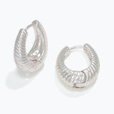 Silver textured hoop earrings on a white background. Available at Be Charmed