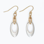 Gold and silver earrings on a white background. Available at Be Charmed