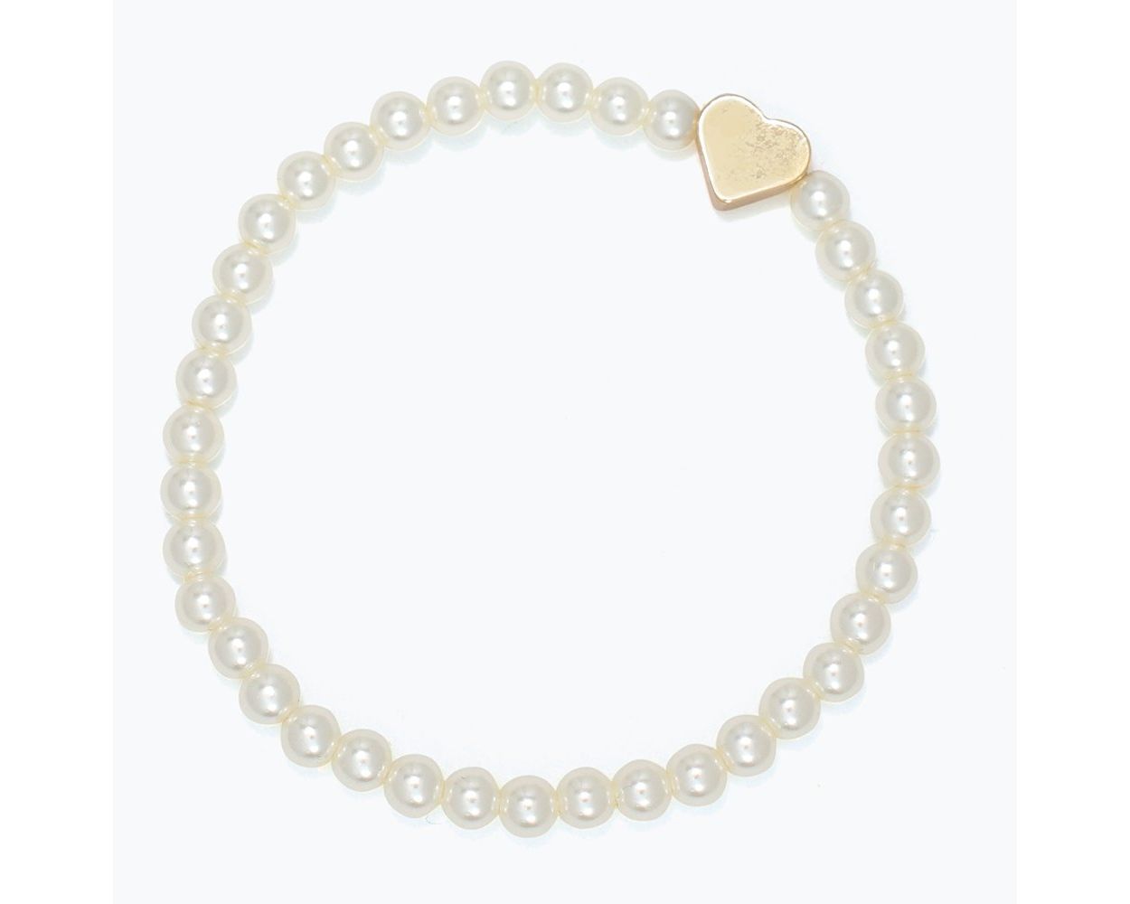 Kids pearl bracelet with a gold heart charm on a white background. Available at Be Charmed. 