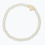 Kids pearl bracelet with a gold heart charm on a white background. Available at Be Charmed. 