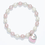 Kids pearl bracelet with a heart-shaped charm on a white background. Available at Be Charmed. 