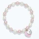 Kids pearl bracelet with a heart-shaped charm on a white background. Available at Be Charmed. 